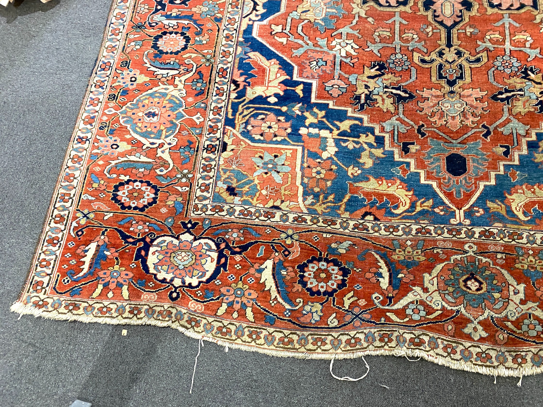 An antique Heriz brick red ground carpet, 370cm x 290cm